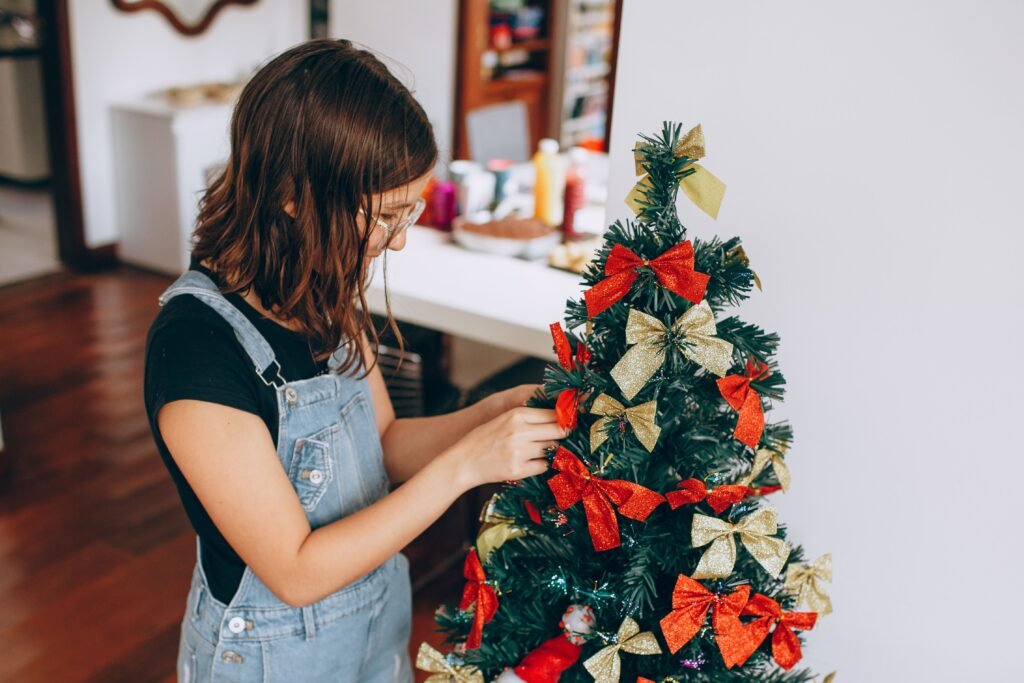 Christmas tree decorated with flowing red ribbon and fabric bows