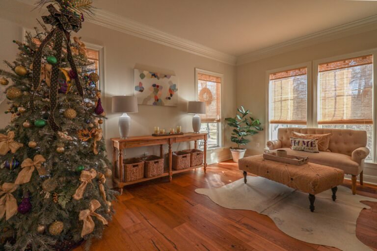 Cozy living room decorated for Christmas with warm lights and a small tree
